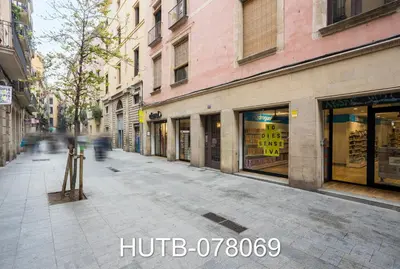 an empty city street with shops and buildings at Palau de la música 9 in Barcelona