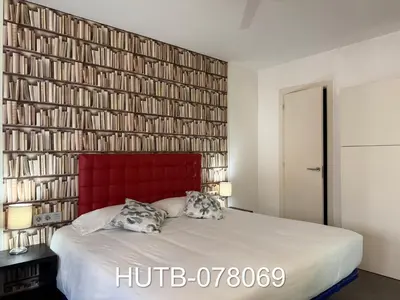 a bedroom with a large bed with a red headboard at Palau de la música 9 in Barcelona
