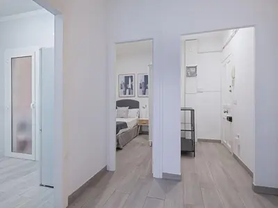 a living room with a brown couch and a hallway at Alcam Baro in Barcelona