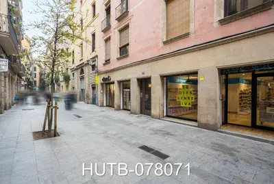 an empty city street with shops and buildings at Palau de la música 11 in Barcelona