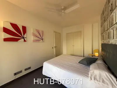 a bedroom with a bed and two paintings on the wall at Palau de la música 11 in Barcelona