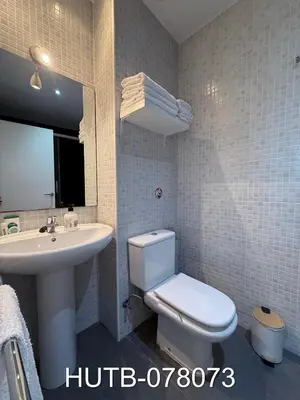 a white bathroom with a toilet and a sink at Palau de la música 13 in Barcelona
