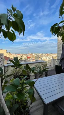 a row of beds sitting on top of a roof at Spacious Penthouse with big private terrace & view in Barcelona