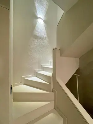 a living room with a chair and a fireplace at Spacious Penthouse with big private terrace & view in Barcelona