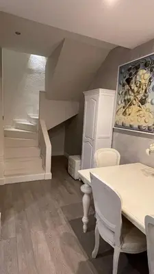 a dining room with a table and a staircase at Spacious Penthouse with big private terrace & view in Barcelona