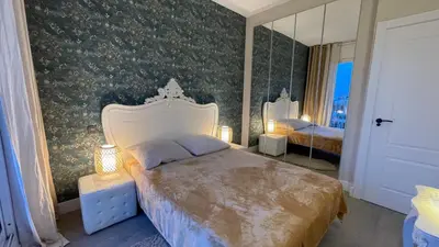 a bedroom with a large bed and a mirror at Spacious Penthouse with big private terrace & view in Barcelona