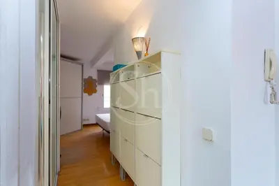 a room with a white dresser and a bedroom at Apartamento con Terraza en Eixample in Barcelona