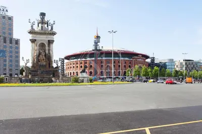 a large building with a clock tower in a city at Bonito apartamento cerca de Plaza España in Barcelona