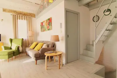a living room with a couch and a table at Mediterrani Vacaciones perfectas y vistas al mar in Sitges