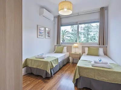 a bedroom with two beds and a window at Alcam Espronceda in Barcelona