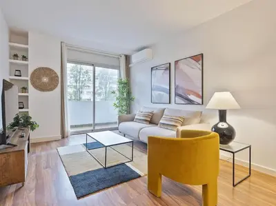a living room with a couch and a chair at Alcam Espronceda in Barcelona