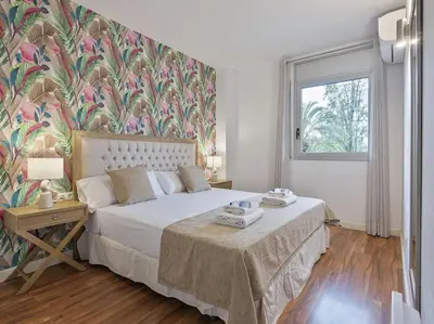 a bedroom with a bed with a floral wallpaper at Alcam Espronceda in Barcelona