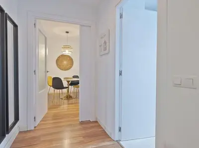 a hallway with a table and a dining room at Alcam Espronceda in Barcelona