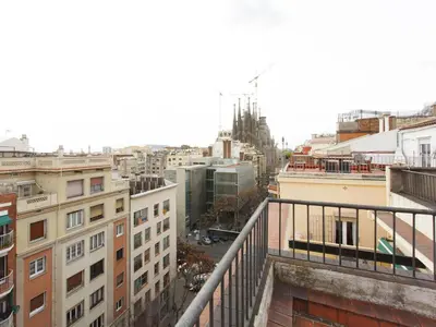 a kitchen with a table and some chairs in it at Top Flat Sagrada in Barcelona