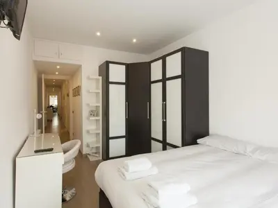 a bathroom with a sink and a toilet and a mirror at Top Flat Sagrada in Barcelona
