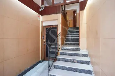 a staircase leading to a door in a building at Moderno Estudio en Eixample in Barcelona