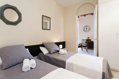 a kitchen with white walls and a wooden floor at Key Plaza Cataluña Bliss in Barcelona