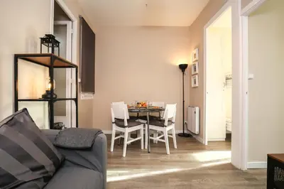 a living room with a table and chairs at The Sants's balcony in Barcelona
