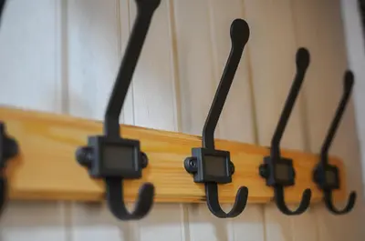 four black electrical cords hanging on a wall at The Sants's balcony in Barcelona