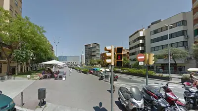 a street with motorcycles parked on the side of the road at The Sants's balcony in Barcelona