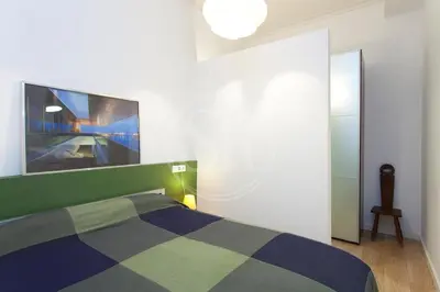 a bedroom with a bed and a tv on the wall at Bonito apartamento en La Rambla del Poblenou in Barcelona