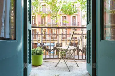 an open door with a chair and a plant at Bonito apartamento en La Rambla del Poblenou in Barcelona