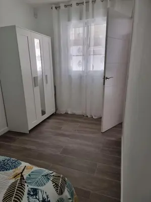 a white cabinet with a mirror in a room at Piso céntrico a estrenar in Vilanova i la Geltrú