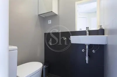 a bathroom with a white toilet and a sink at Apartamento en Sagrada Familia 2 in Barcelona
