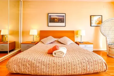 a bedroom with a bed with two towels and two lamps at Villa Romady in Sant Pere de Ribes