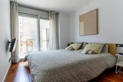 a bedroom with a bed and a large window at Lovely apartment Sagrada Familia in Barcelona