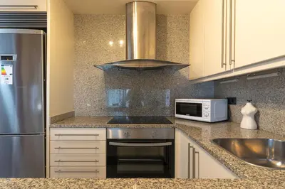 a kitchen with a stainless steel refrigerator and a microwave at Lovely apartment Sagrada Familia in Barcelona