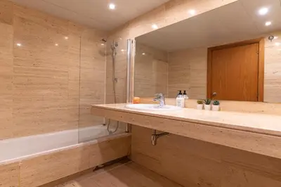 a bathroom with a sink and a shower and a tub at Lovely apartment Sagrada Familia in Barcelona