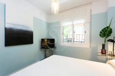 a white room with a window and a toilet at Precioso apartamento en Les Corts in Barcelona