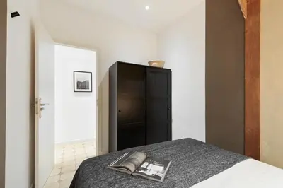 a kitchen with white cabinets and a refrigerator at Jaiz - 2 bedrooms and terrace in Eixample Esquerra in Barcelona