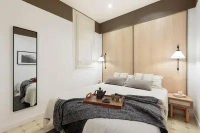 a living room with a couch and a table at Jaiz - 2 bedrooms and terrace in Eixample Esquerra in Barcelona