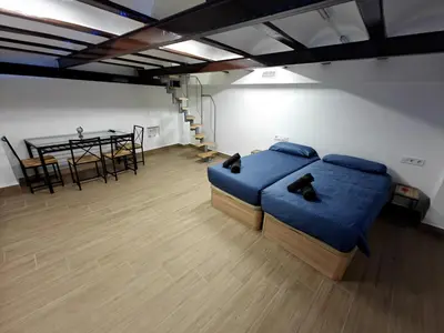 a bedroom with a bed and a table with a dining room at Gorgeous Appartment in Martorell-Barcelona in Martorell