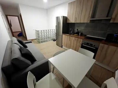 a living room with a couch and a table and a kitchen at Gorgeous Appartment in Martorell-Barcelona in Martorell