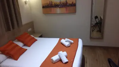a hotel room with two beds with towels at Hostal Barcelona Travel in Barcelona