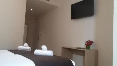 a bedroom with a bed and a tv on a wall at Hostal Barcelona Travel in Barcelona