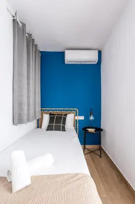 a hallway with white walls and wooden floors at The Collection Barcelona - Eixample 4BD 2BTh with private Terrace in Barcelona