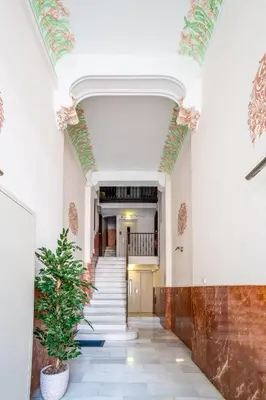 a hallway with a door and a potted plant at The Collection Barcelona - Eixample 4BD 2BTh with private Terrace in Barcelona