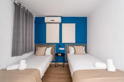 a bedroom with two bunk beds and a blue wall at The Collection Barcelona - Eixample 4BD 2BTh with private Terrace in Barcelona