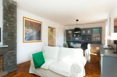 a living room with a white couch and a fireplace at Céntrico apartamento familiar in Barcelona