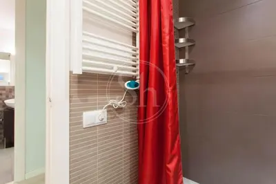 a shower with a red curtain in a bathroom at Apartamento para 4 Barcelona in Barcelona