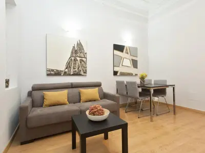 a living room with a couch and a table at Gran Via Apartment in Barcelona