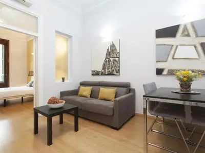 a living room with a couch and a table at Gran Via Apartment in Barcelona
