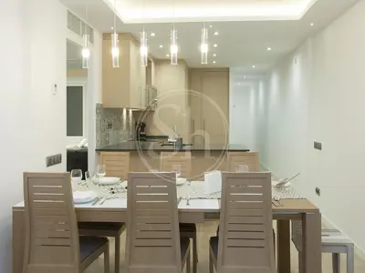 a kitchen with a dining room table and chairs at Nice apartment on Valencia Street in Barcelona