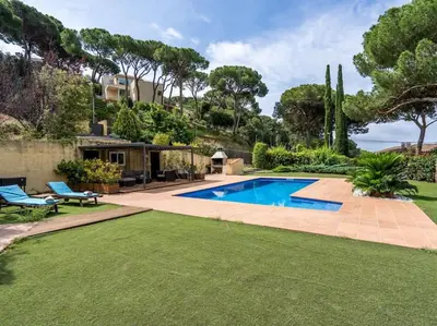 a backyard with a swimming pool and green grass at Villa Llum with Views, Pool 25 minutes from BCN in Alella