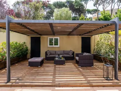 a patio with a couch and chairs under a pergola at Villa Llum with Views, Pool 25 minutes from BCN in Alella