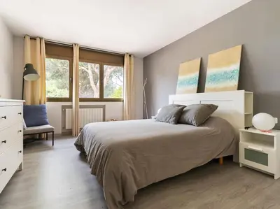 a bedroom with a large bed and a window at Villa Llum with Views, Pool 25 minutes from BCN in Alella